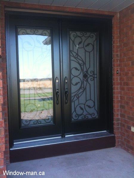 Front door. Double entry steel insulated. Black. Full wrought iron glass inserts. Rochester glass design